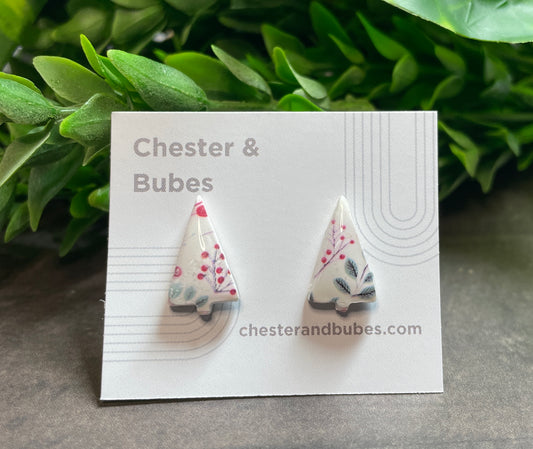 Festive pattern Christmas tree earrings on a 'Chester & Bubes' branded card with green leaves in the background