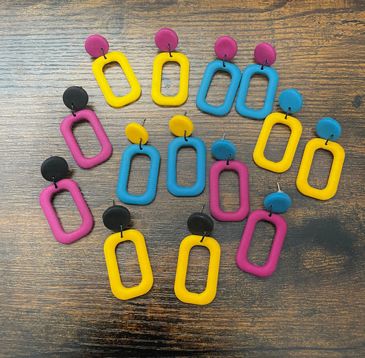 Colourful earrings on a wooden surface